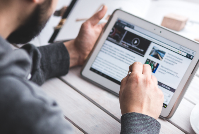 Person using a device reading a website.